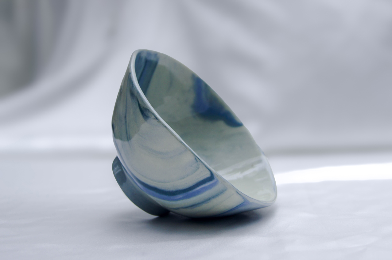 Photo of artistic ceramic bowl in blues and greens
