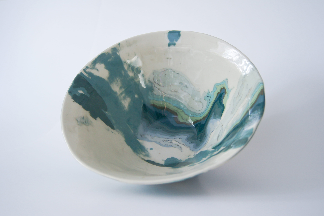 Photo of artistic ceramic bowl in blues and greens