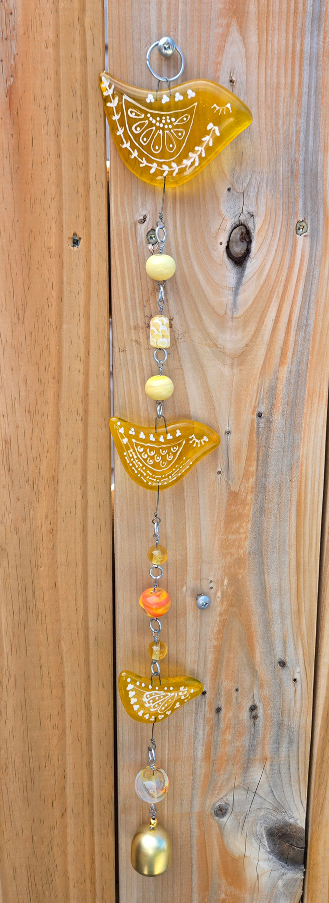 Photo of glass hanging art piece with birds and beads