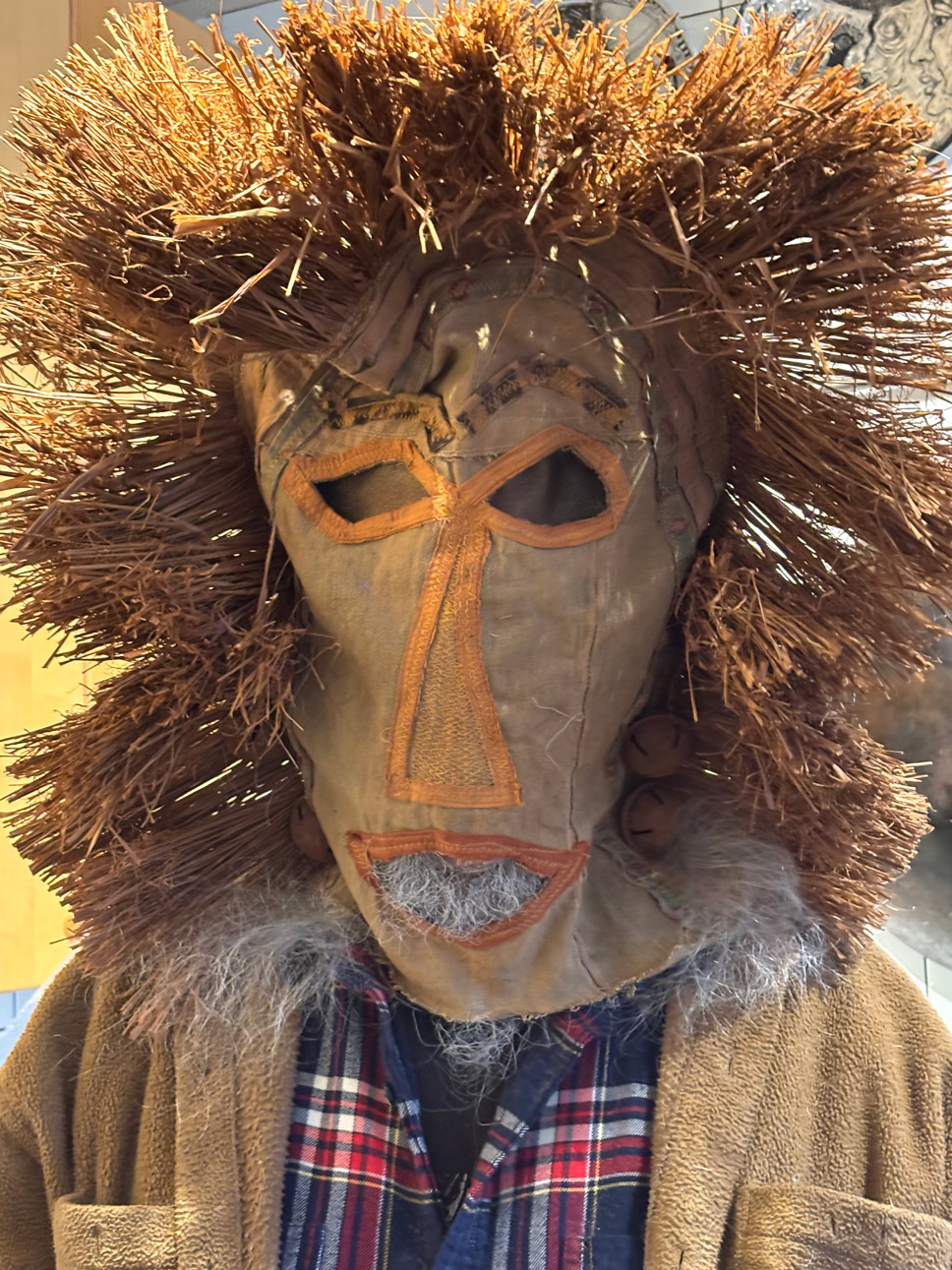 Photo of handmade mask with eyeholes and straw hair