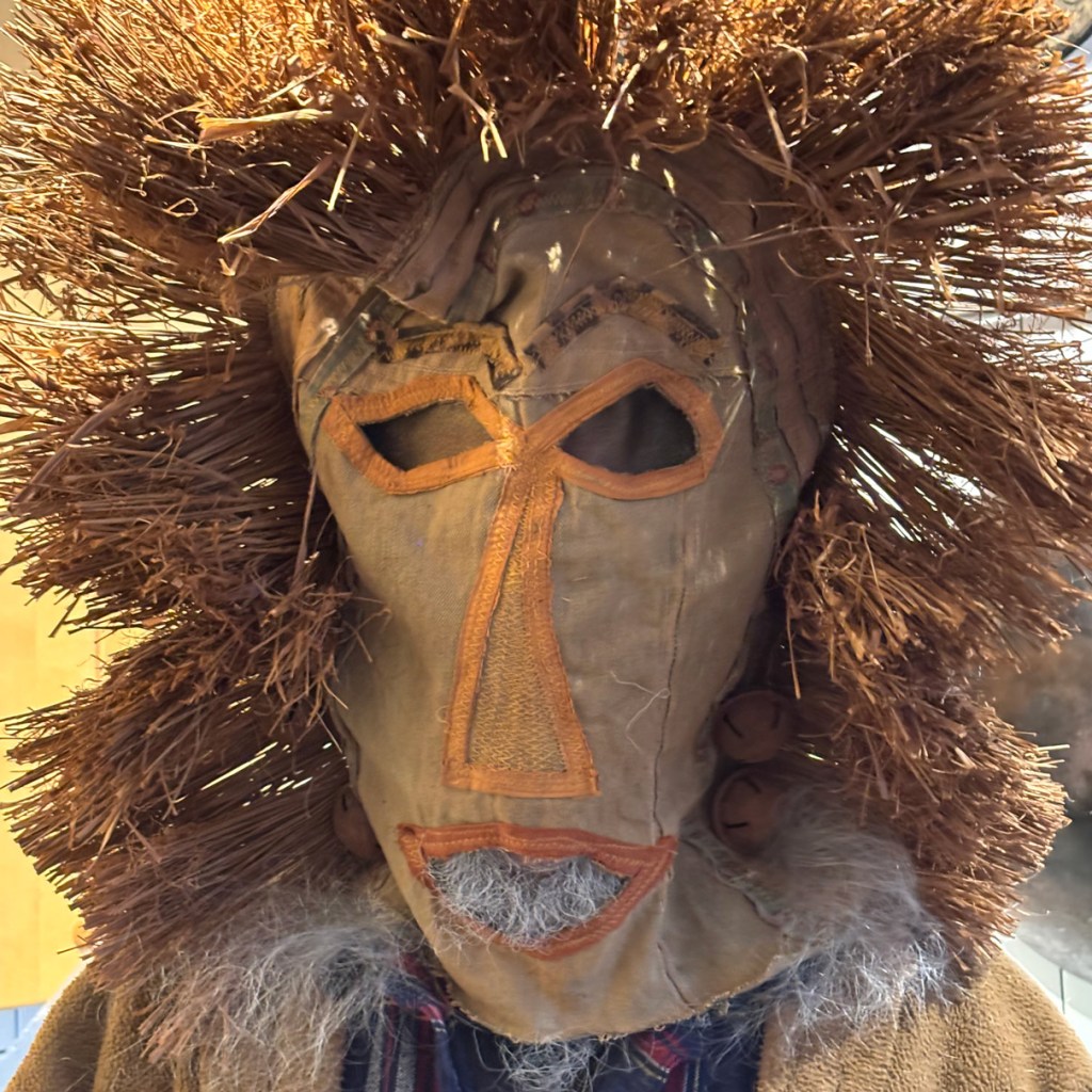 Photo of handmade mask with eyeholes and straw hair